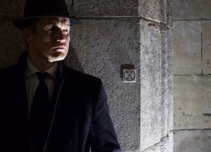 An image of a man in a hat and coat, Spy Game. Agent November