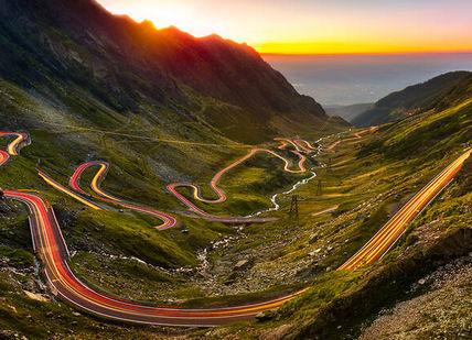 An image of a mountain road at sunset, Dinner in Bucharest. Caru' cu Bere
