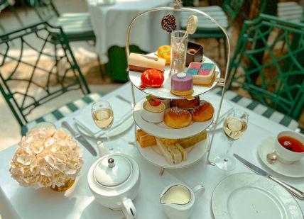 An image of a table with a tea set, Original Sweetshop Afternoon Tea. Chesterfield Mayfair Hotel