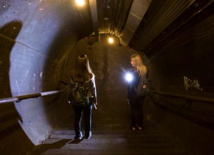 An image of a person walking down a dark tunnel, Private Secret Underground Tour. Hidden London