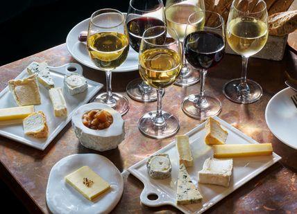 An image of cheeses on a black background, Cheese and Wine Pairing. Le Bar