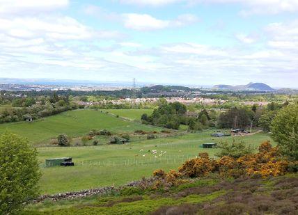 An image of a view of a city from a hill, Private Scottish Highlands Nature Tour. Rishi's Edinburgh Tours