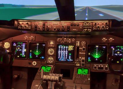 An image of a cockpit with a view of the runway, 60-minute full-motion flight simulation experience. Virtual Aerospace
