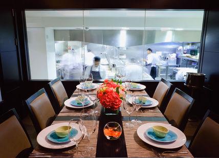 An image of a restaurant setting with a table set for dinner, Benares Chef’s Table. Benares Restaurant and Bar