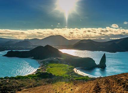 An image of the sun setting over the pito islands, Exclusive Escape to the Galápagos. Coast to Coast Galapagos