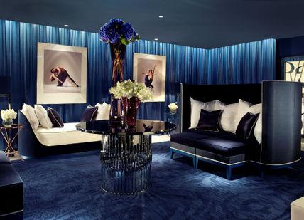 A living room with a blue carpet.