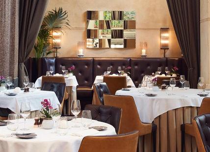An image of a restaurant setting with tables and chairs, La Chapelle. Galvin