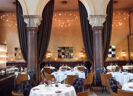 An image of a restaurant with tables and chairs, La Chapelle. Galvin