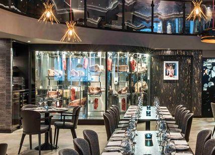 An image of a restaurant with blue booths and tables, Three Courses and Free-Flowing Prosecco at M Threadneedle. M Threadneedle