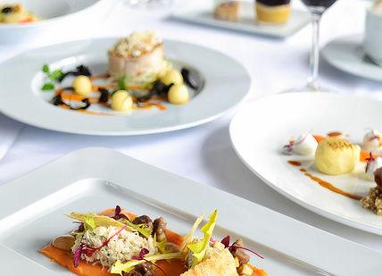 An image of a table setting with plates of food, Five-course tasting menu. OXO Tower Restaurant