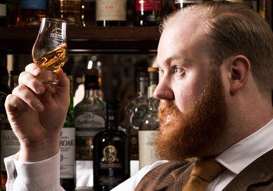 An image of a man drinking a glass of whiskey, 100 Years of Whisky Journey. Scotch at The Balmoral