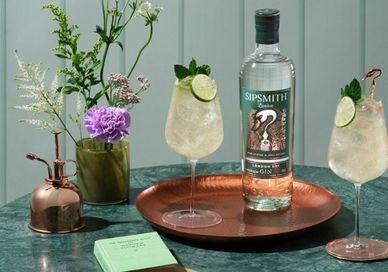 An image of a bottle of gin with a glass and a copper tray, Gin masterclass. Sipsmith Distillery