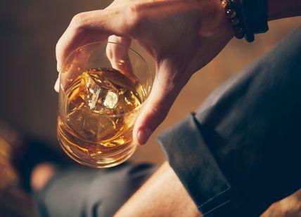 An image of a person holding a glass of whiskey, Whisky Tasting. Soho Whisky Club
