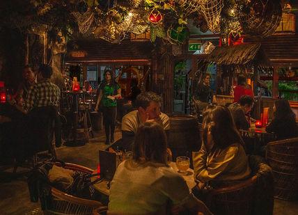 An image of a bar with people sitting around, Sugar Cane Bar. Sugar Cane Bar