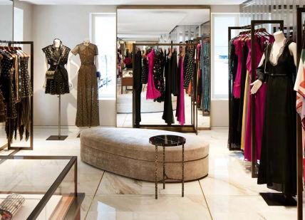 An image of a closet with clothes and shoes, Selfridges, London. Tailored Styling