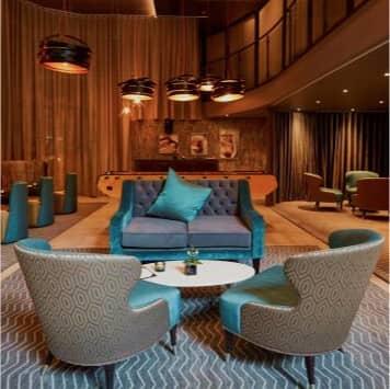 A reception area at a hotel with a lounge area.