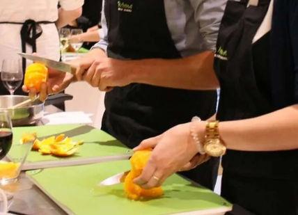 A couple segmented oranges in a cooking class