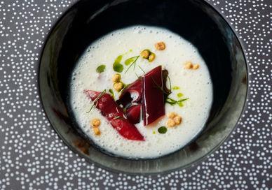 An image of a plate of food on a table, Eight-Course Tasting Menu. Club Gascon