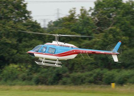 An image of B206 Jet Ranger and rainbow