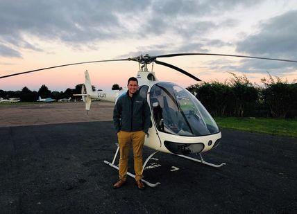 A person standing in front od Guimbal Cabri G2 helicopter