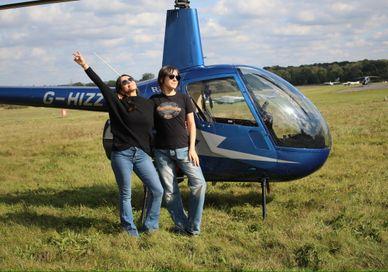 Image of people seating in front of Helicopter