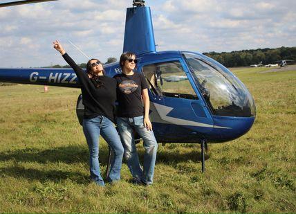 Image of people seating in front of Helicopter