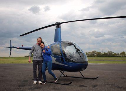 Image of people seating in front of Helicopter