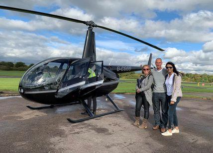 An image of a helicopter and people standing