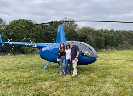 An image of a helicopter and people standing