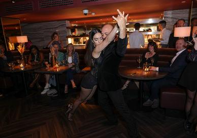 An image of man and woman dancing Tango at Gaucho restaurant