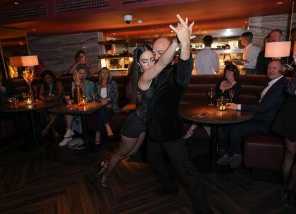 An image of man and woman dancing Tango at Gaucho restaurant