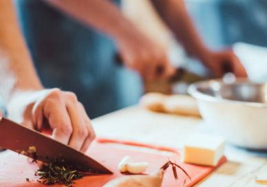 An image of a person cutting up food, Venue Hire for 7.5 Hours. Kitchen Table NYC