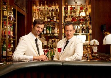 An image of man drinking whisky at the bar