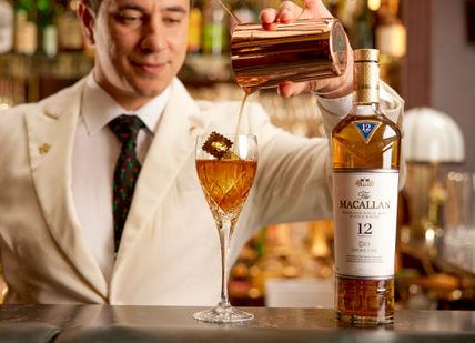 An image of person pouring machallan whisky at the Stable bar