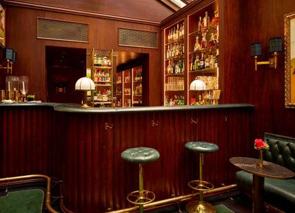 An image of bar and chairs at stable bar. MIlestone hotel