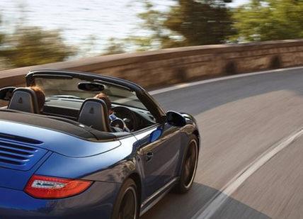 An image of a blue porsche convertible driving down a road, Self Driving Tour On The Canary Islands. On The Road- Spain