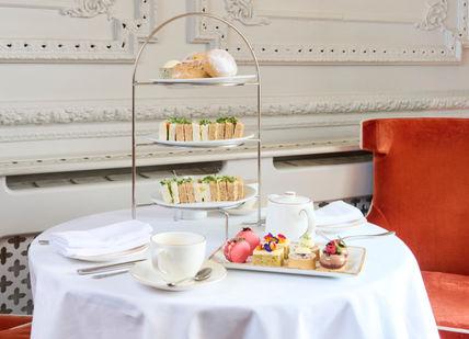 An image of a table with a cake and tea, Afternoon Tea. Ba'Bar at The rosette Afternoon Tea