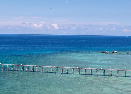 An image of a beach with a pier, Private Ten-Day Motorcycle Tour. Samadhi Retreats