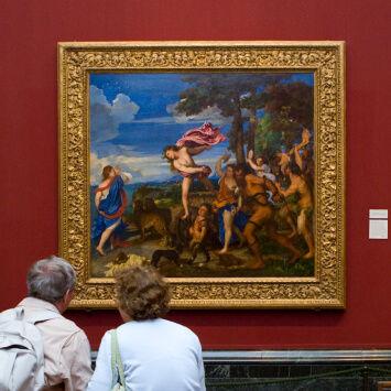 People looking at a painting in a museum.