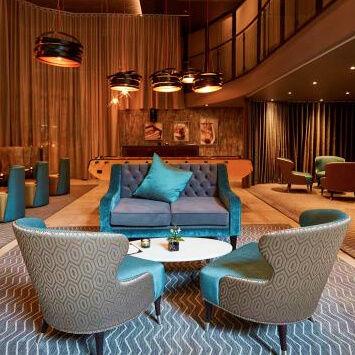A reception area at a hotel with a lounge area.