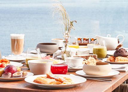 An image of a table with food and drinks, A 5-course tasting menu at Ibiza. 7Pines Kempinski Ibiza Resort