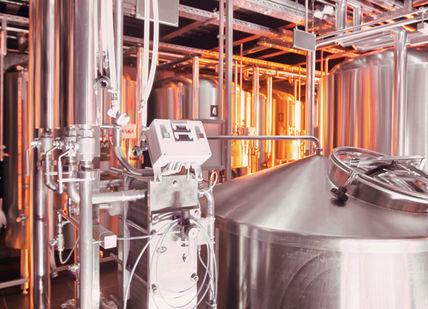 An image of a brewery with stainless tanks, Dinner. Adnams Hotel