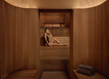 An image of woman taking a sauna