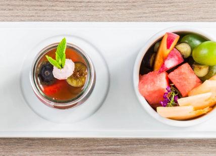 An image of a plate with a cup of tea and a bowl of fruit, Seven-Day Sleep Recovery Programme. Albir Hills Resort S.A.U. (SHA Wellness Clinic)