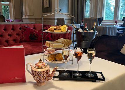 An image of a table with food and drinks, Laurent-Perrier Afternoon Tea Experience. Alexander House Hotel