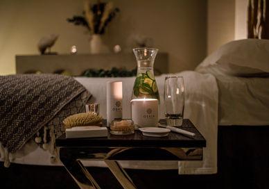 An image of a bed with a candle and a book, Renew and Refresh Spa Break. Alexander House Hotel