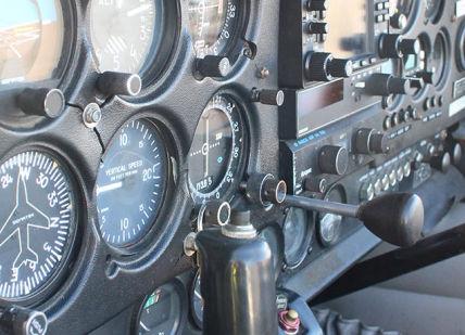 An image of a dashboard with a clock, 1h trial lesson in 2 seater plane. Almat Flying Academy