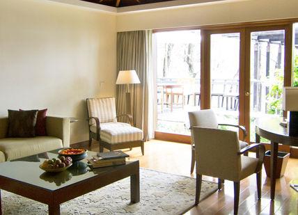 An image of a living room with a couch and a table, Detox Together. Ananda in the Himalayas