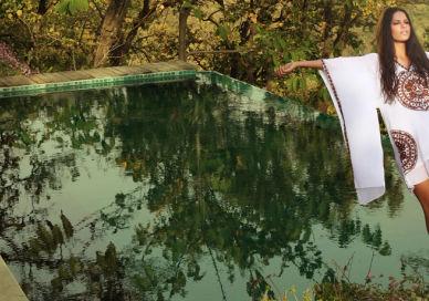 An image of a woman standing by a pool, Personal Ayurvedic Programme. Ananda in the Himalayas