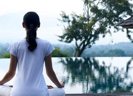An image of a woman meditating in a pool, Anantara Golden Triangle Resort and Elephant Experiences. Anantara Golden Triangle Elephant Camp & Resort